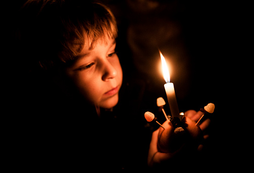 Young person holding a christingle